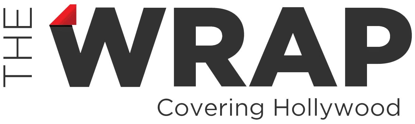 The image shows the logo of "The Wrap" with the tagline "Covering Hollywood." The "W" in "WRAP" has a red corner fold.